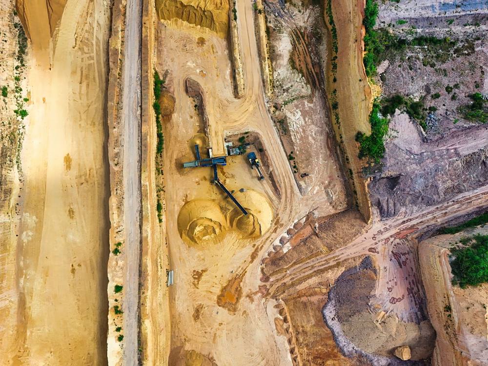 Aerial view of an excavation site with roads and machinery