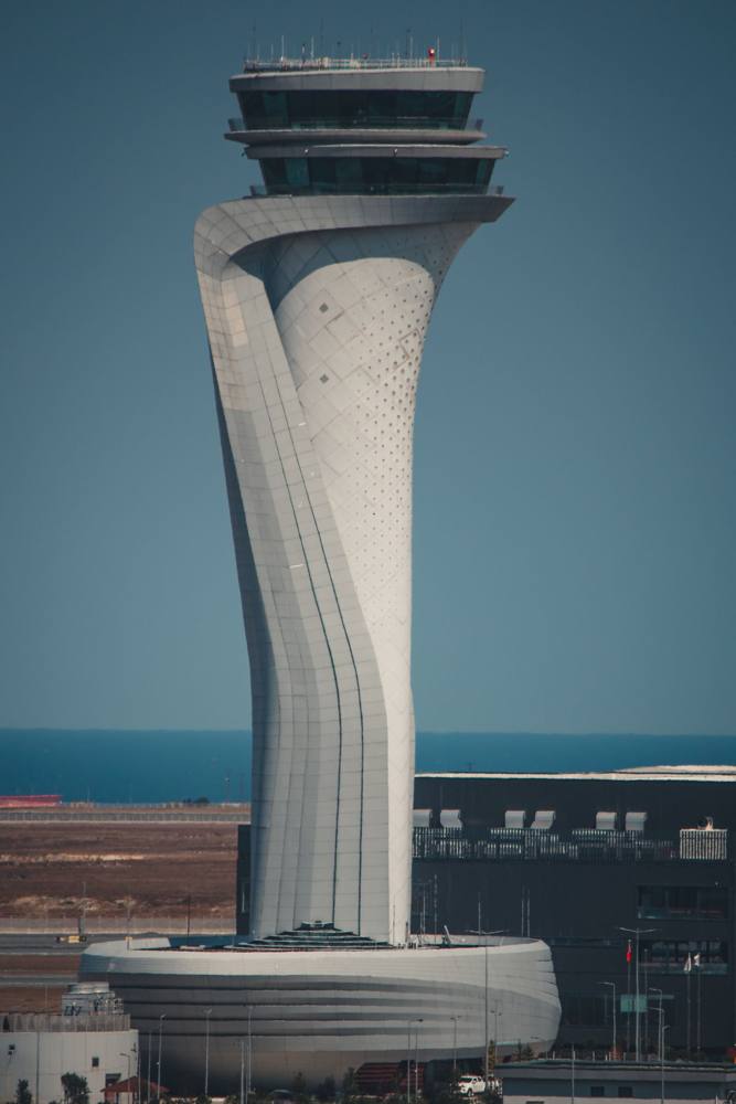 An air traffic control tower against a blue sky